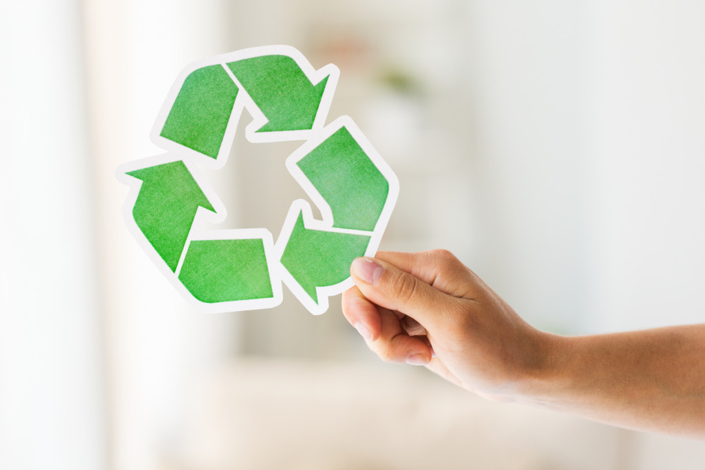 holding a recycle logo
