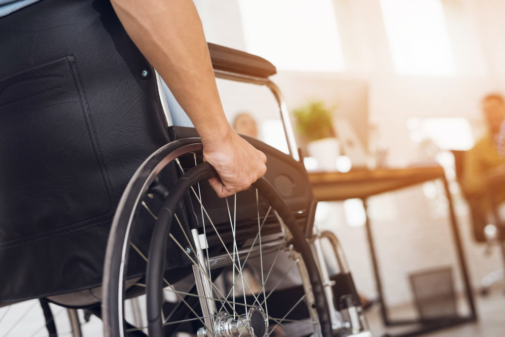 Close up portrait of a man in wheel chair going office 