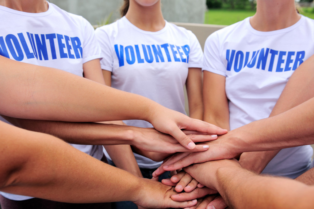 a group of volunteers with hands together