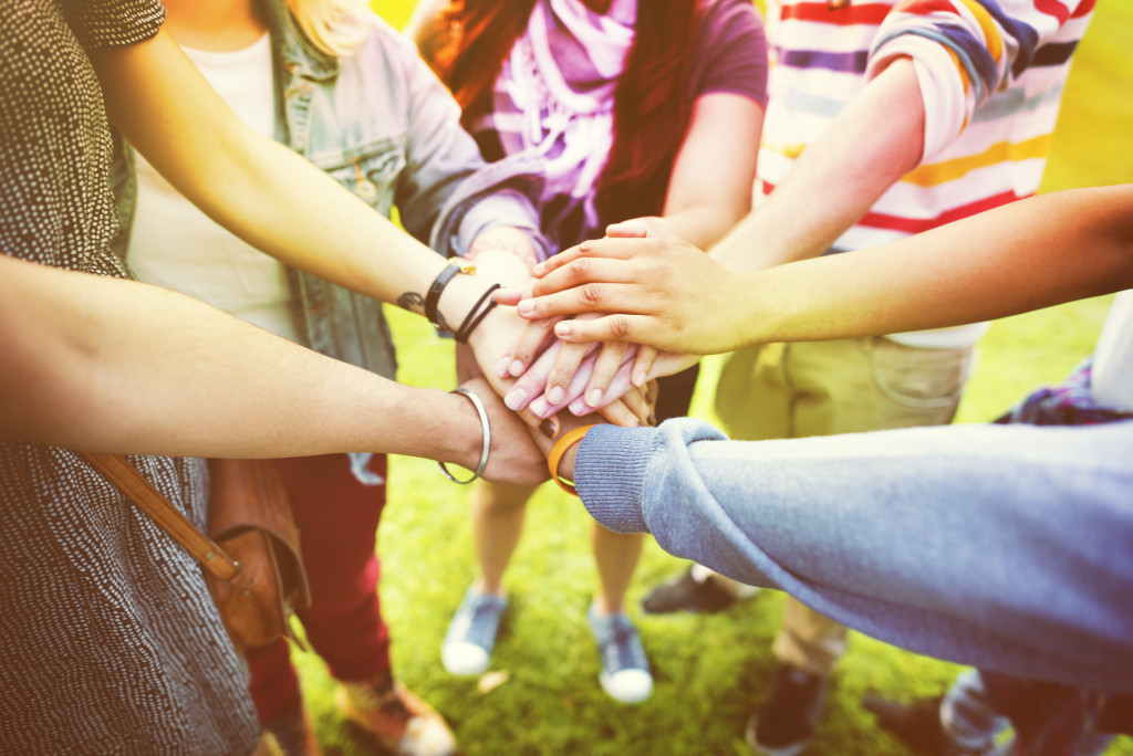 a group of people joining hands