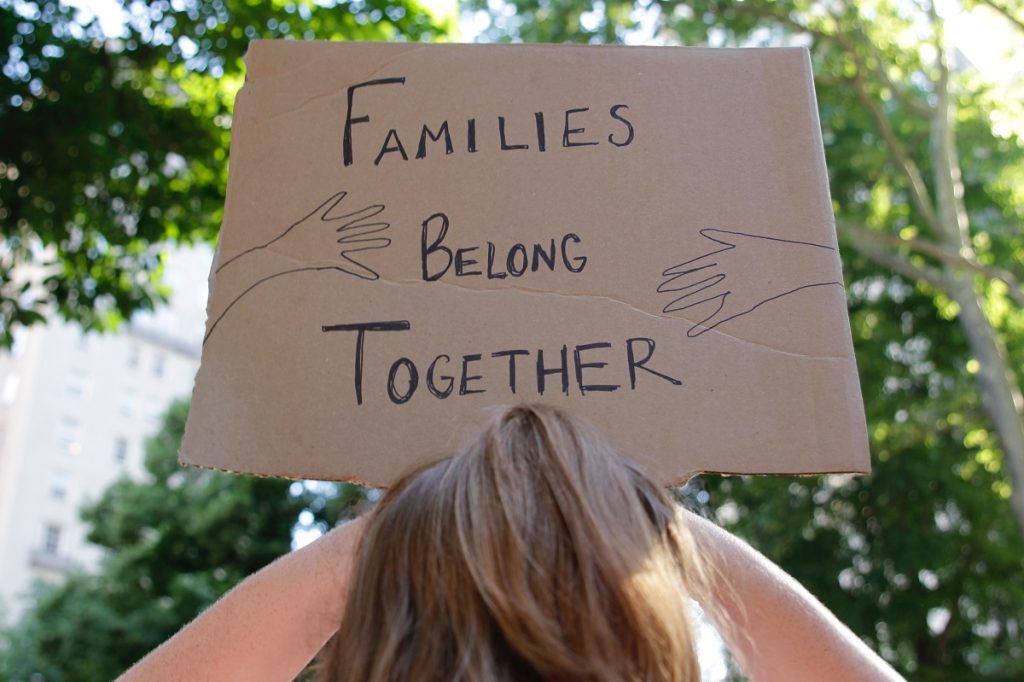 Families belong together written on a cardboard