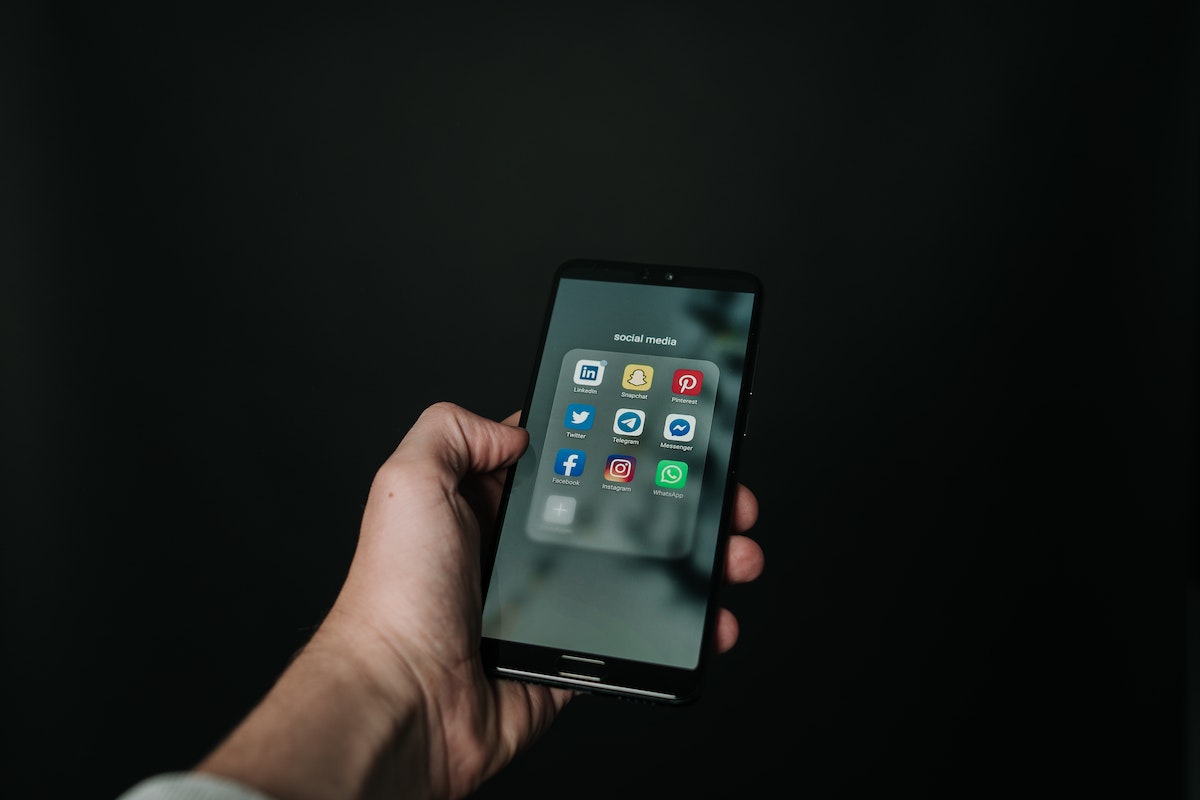 Photo of Hand Holding a Black Smartphone