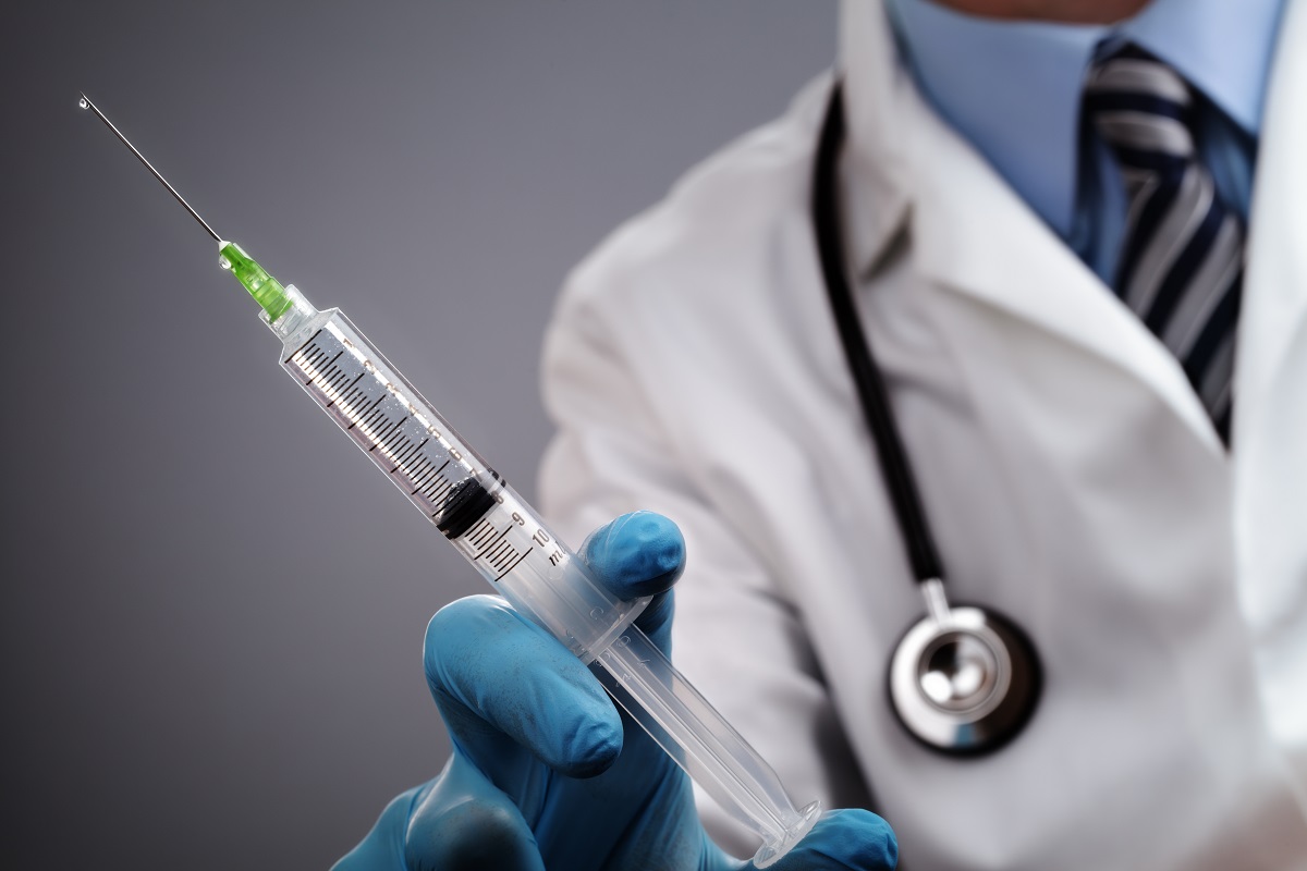 A doctor holding a syringe