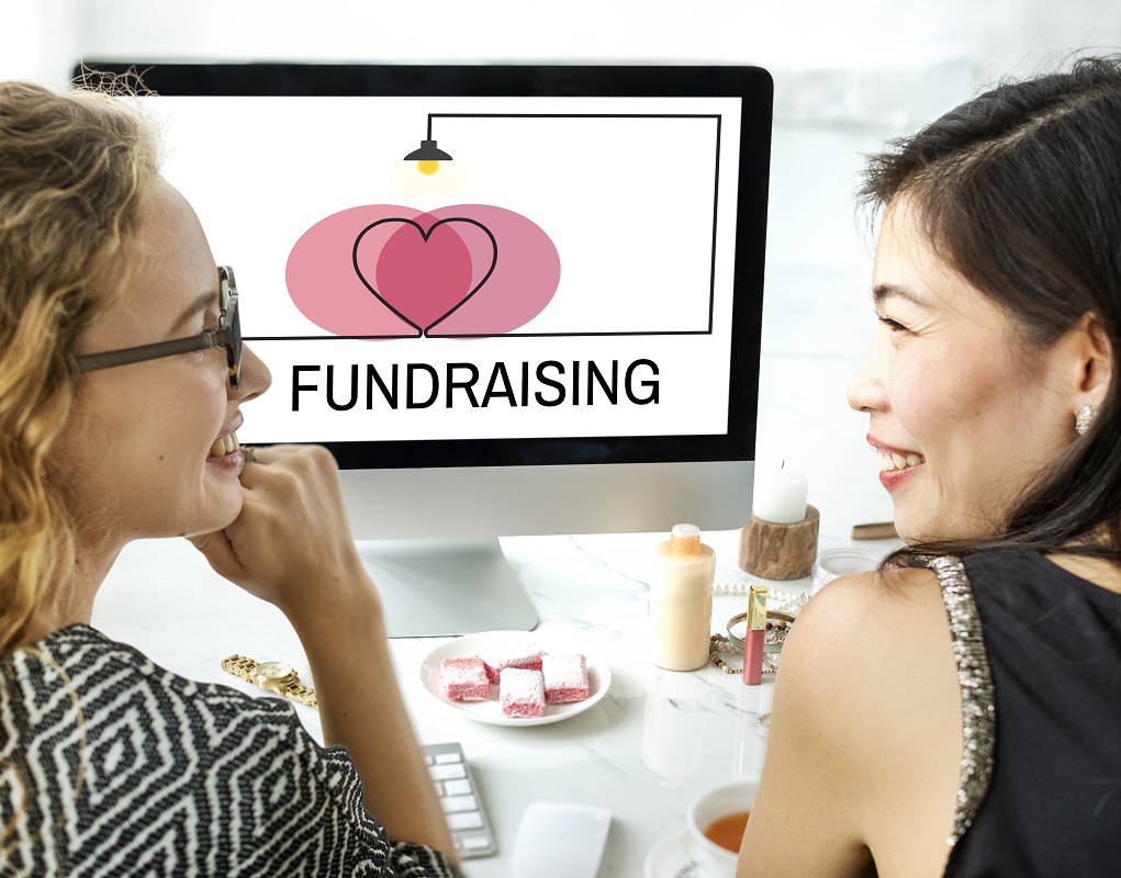 two women smiling while planning their funding options