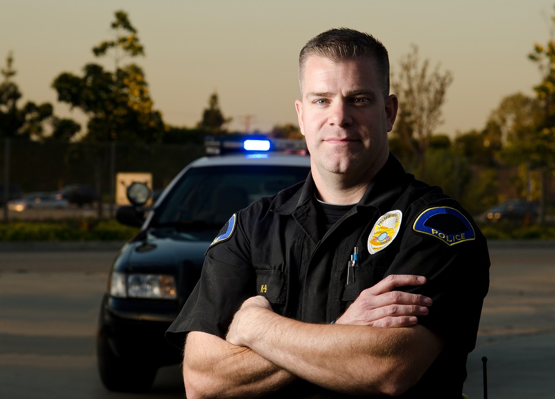 A policeman in front of his patrol car