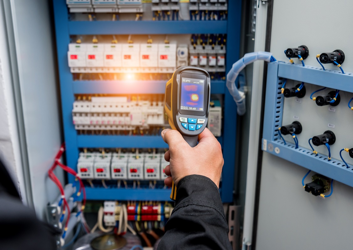 man using thermography device for maintaining equipment